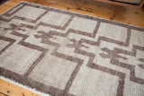 Close-up of vintage Tulu rug texture, showing stepped pattern in silver and grey.