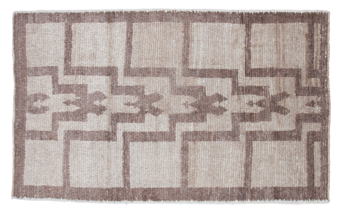 Unique vintage Tulu rug features stepped geometric pattern in silver and grey tones.