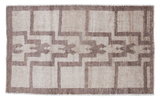 Unique vintage Tulu rug features stepped geometric pattern in silver and grey tones.