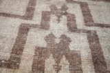 Textured pile of vintage Tulu rug with stepped brown and beige geometric pattern.