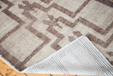 Textured pile and woven reverse of the Tulu rug's silver and grey germinating plant design.