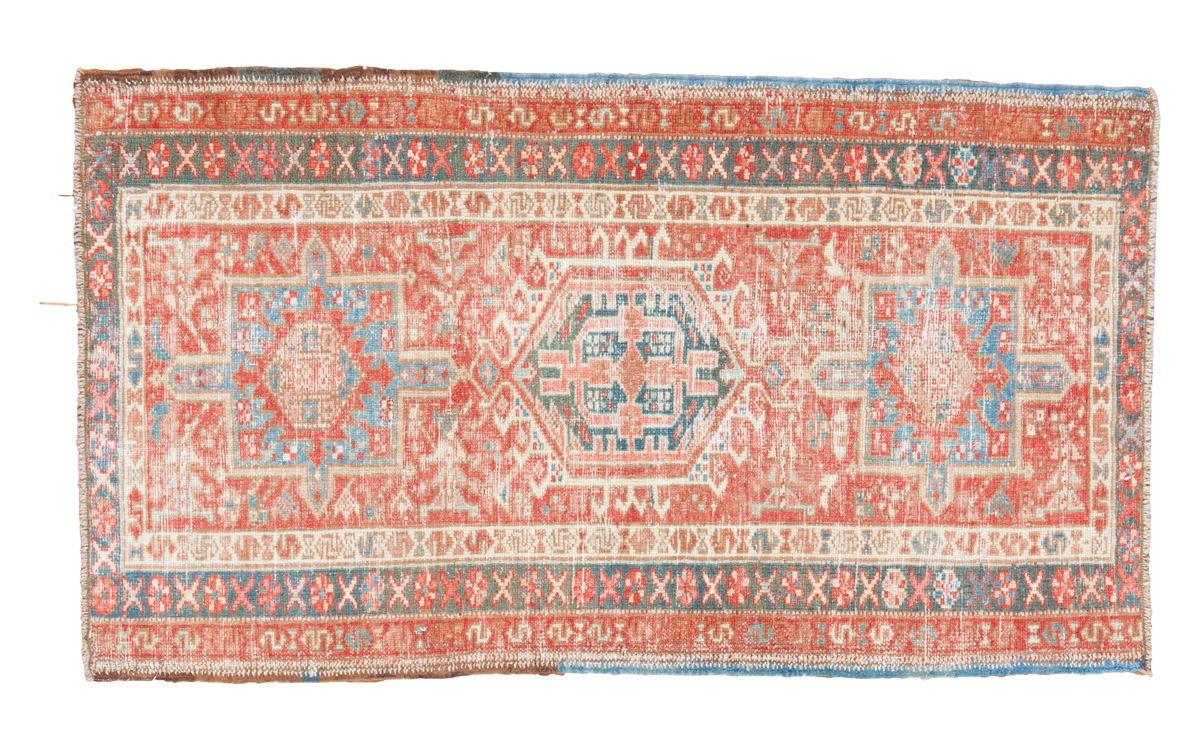 Vintage Persian Karaja runner features geometric medallion in red grapefruit, sky blue, and mallard green.