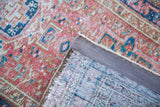Vintage Karaja rug corner displaying bright red geometric pile and hand-knotted back.