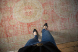 A view from above showing the distressed, low-pile texture of an antique Khotan carpet.