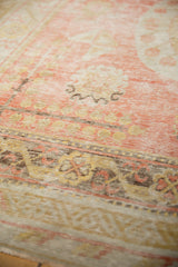 Soft shades of red, beige, and charcoal abrash on the distressed antique Khotan pile.