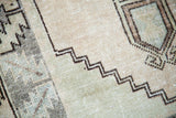 Hand-knotted vintage Oushak rug with geometric zigzag pattern in faded celadon and warm ivory.