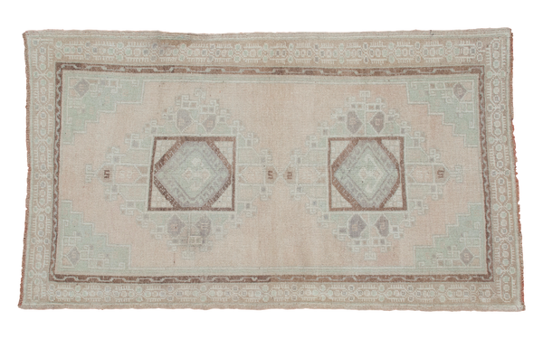 Vintage Oushak rug: peach field, pale mint spandrels, double geometric medallions, 3'7" x 6'2".
