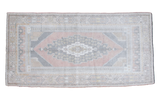 Vintage Oushak rug runner features a geometric medallion in peach, grey, and soft neutral tones.