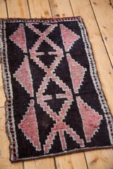 Grapefruit red stepped-geometric pattern on deep ground of Vintage Kars rug.