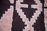 Vintage Kars rug's stepped geometric pattern in deep brown, grapefruit red, and ivory.