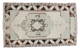 Vintage Oushak rug with pale sea foam green, ivory, charcoal, black geometric motif.