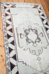 Charcoal and blanched ivory minimalist geometric motif of the vintage Oushak rug.