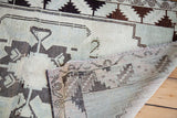Underside and geometric pattern of a vintage Oushak rug in pale sea foam green and charcoal.