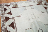 Vintage Oushak rug: blanched ivory pile texture with charcoal minimalist geometric patterns.