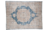 Distressed vintage Oushak carpet with sky blue field, blanched ivory medallion, and delicate floral pattern.