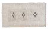 Vintage Oushak rug with three charcoal medallions on a simple neutral field, 2'4