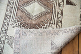 Distressed Oushak rug reverse showing hand-knotted weave and pattern foundation.