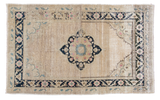 Distressed Oushak rug: creamy ivory abrash field, navy charcoal medallion, powder blue details. 3'8