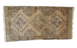Vintage Oushak rug with muted geometric triple medallion on a soft beige field.