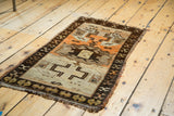 Vintage Turkish Oushak rug corner showing dark brown geometric border and pale ivory field.