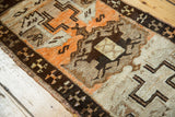 Vintage Oushak rug with distinctive tangerine orange, pale ivory, and brown geometric designs.