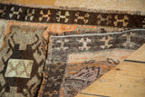 Vintage Oushak rug folded corner showing tribal patterns, short fringe, tangerine, brown, ivory.
