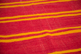 Soft wool texture of vibrant red and yellow stripes on a Moroccan Kilim.