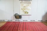 Cranberry red vintage Moroccan Kilim runner with dark vertical stripes and flatweave texture.