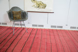 Cranberry red vintage Moroccan Kilim runner displaying its woven texture and bold dark stripes.