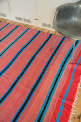 Geometric striped Moroccan kilim flatweave with bubble gum pink, bright blue, and black.