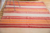Soft woven vintage Moroccan Kilim runner with bright orange, cranberry red, ivory, grey stripes.