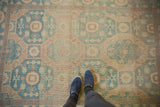 Aqua sea foam green Khotan rug with muted peach geometric pattern, showing abrashes underfoot.