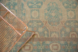 Low pile traditional Khotan rug pattern in aqua, sand, and muted rust.