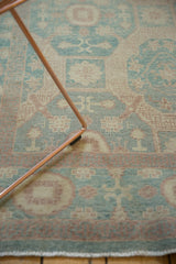 Detail of Egyptian Khotan rug in aqua, peach, and beige, with low pile and unique patterns.