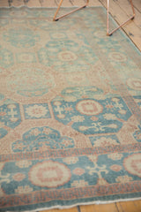 New Egyptian Khotan rug's low pile and intricate aqua green and peach-beige stylized motifs.