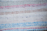 Soft woven texture of a vintage rag rug, with stripes of ivory, light blue, and soft pink.