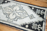 Close-up of the geometric black and ivory pattern with beige accents on vintage Oushak rug.