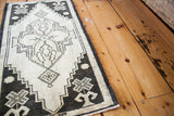 Vintage Oushak runner close-up, highlighting bold black, ivory, and beige geometric pattern.