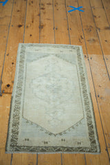 Vintage Oushak rug's lower corner, featuring charcoal bronze geometric border and fringe.