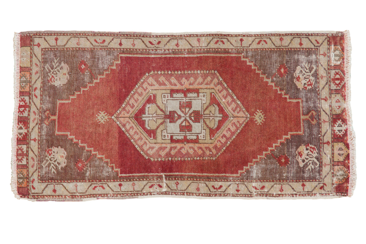 Vintage distressed Anatolian runner with bold red field, central medallion, and grey spandrels.
