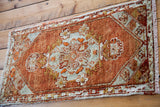 Hand-knotted 1940s Oushak runner in tomato orange red and pale green-grey.