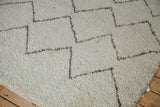 Vintage Moroccan rug showing thick ivory wool pile with silver brown zig-zag lines.