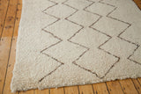 Thick ivory pile on a vintage Moroccan rug with silver brown zig-zag pattern and fringe.