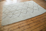 Textured ivory Moroccan rug pile with silver brown zig-zag geometric pattern.