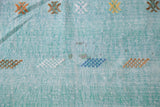 Detail of pretty blue woven kilim rug with embossed art silk geometric patterns.