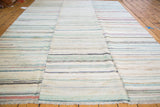 Hand-woven vintage rag rug detail: pastel, ivory, charcoal striped linen texture with visible seam.