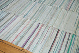 Striped texture on vintage rag rug with pastel and neutral recycled linen weaves.