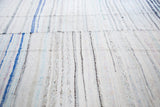 Hand-woven vintage rag rug texture with vertical ivory, blue, and pastel stripes.