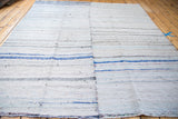 Vintage hand woven rag rug featuring horizontal pastel blue, ivory, and charcoal stripes.