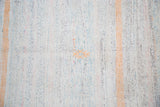 Textured hand woven vintage rag rug with an orange stripe and central pastel stitched motif.